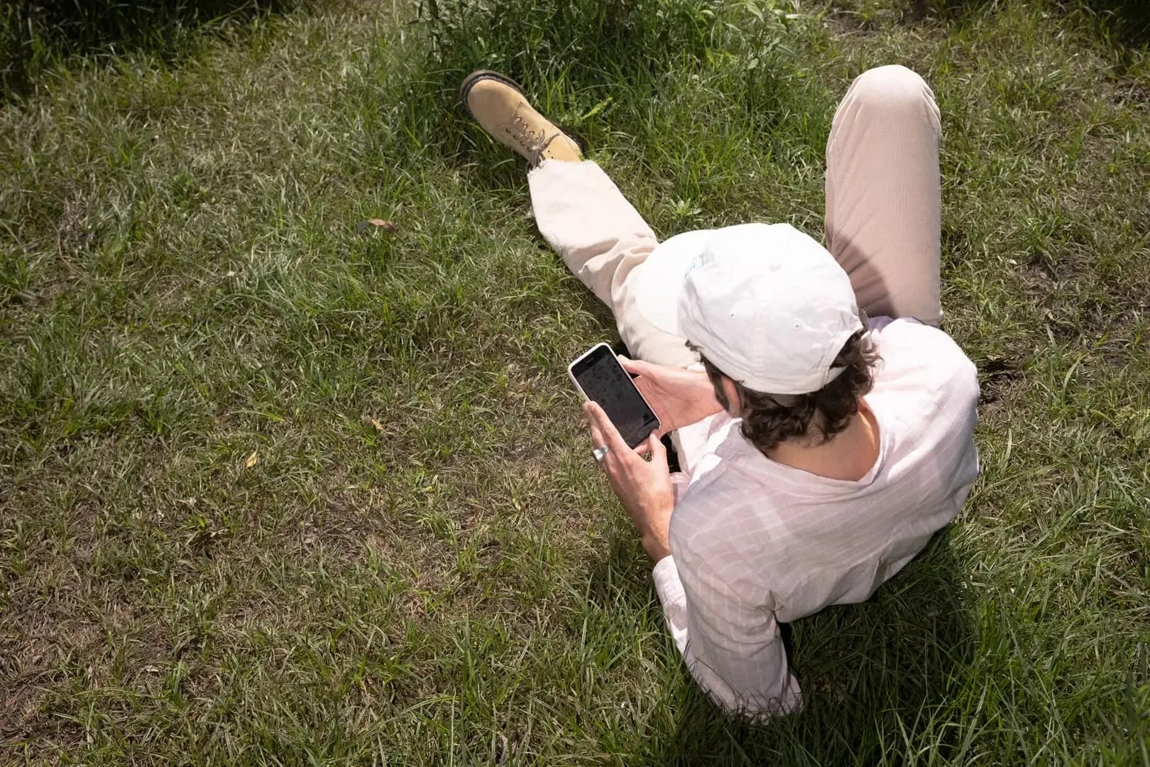 Person in the grass using the Anyfin app